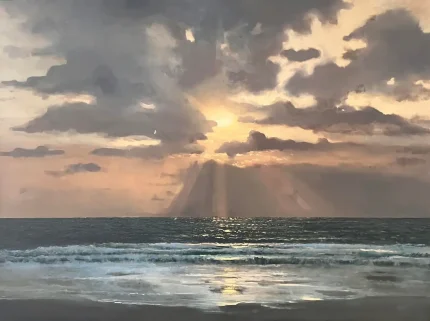 Sunset over ocean with dramatic clouds
