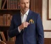 Editorial tailoring styling a fine art silk scarf around the collar of a bespoke coat