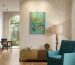 Statement art for modern living room: large-scale original painting creating architectural focal point above designer sofa